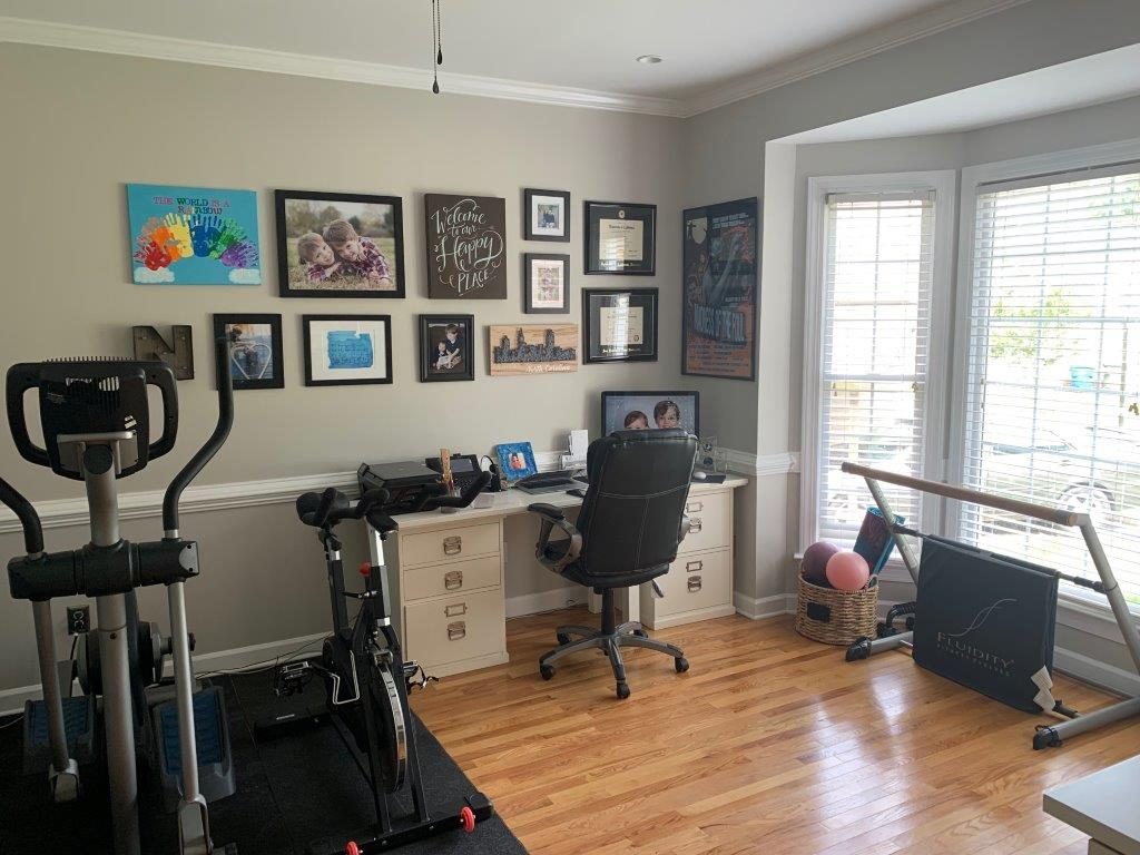 Desk with wall of photos and signs overhead.