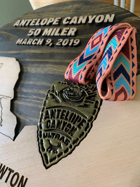 A close-up of the medal held in place by the carved wood outline.