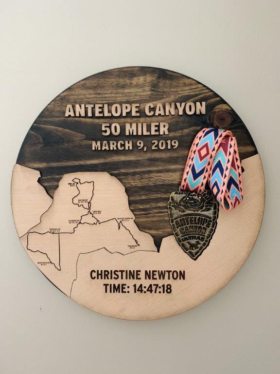 Antelope Canyon Medal Display created by Mae Armstrong. Medal is held in the outline of a slot canyon with the course map in a mesa.