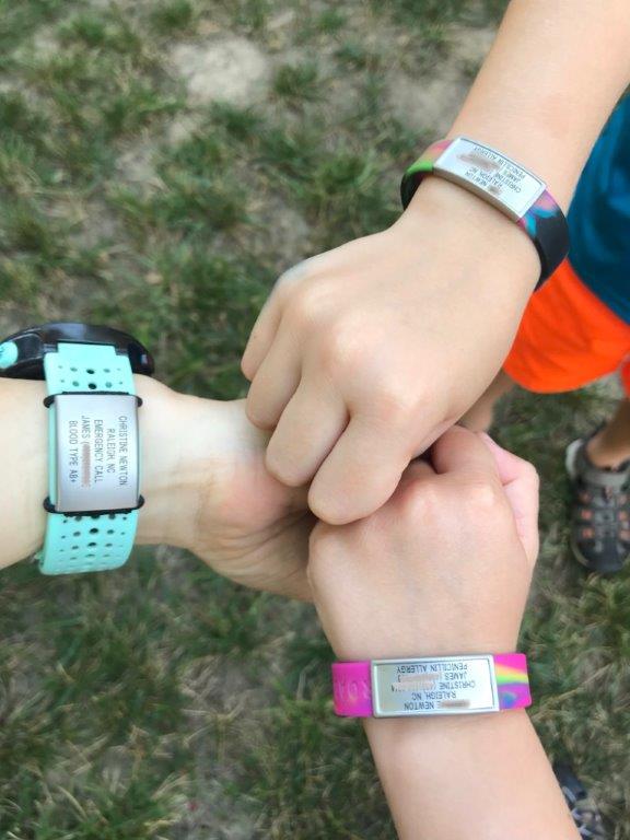 My wrist and the kids, wearing our RoadiDs.
