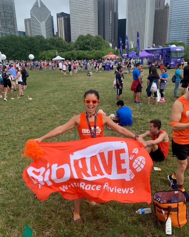 BibRave Co-Founder Jessica Murphy holding a BibRave banner at the RnR Chicago post-race celebration