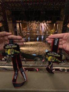 Holding our half marathon medals in front of the Hamilton musical stage.