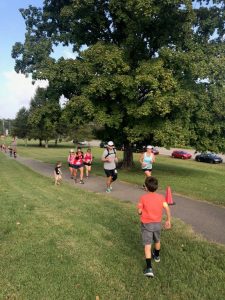 Running towards the last 0.2 miles of the course and spotted by my kids. They ran up to greet me and run me to the finish line.
