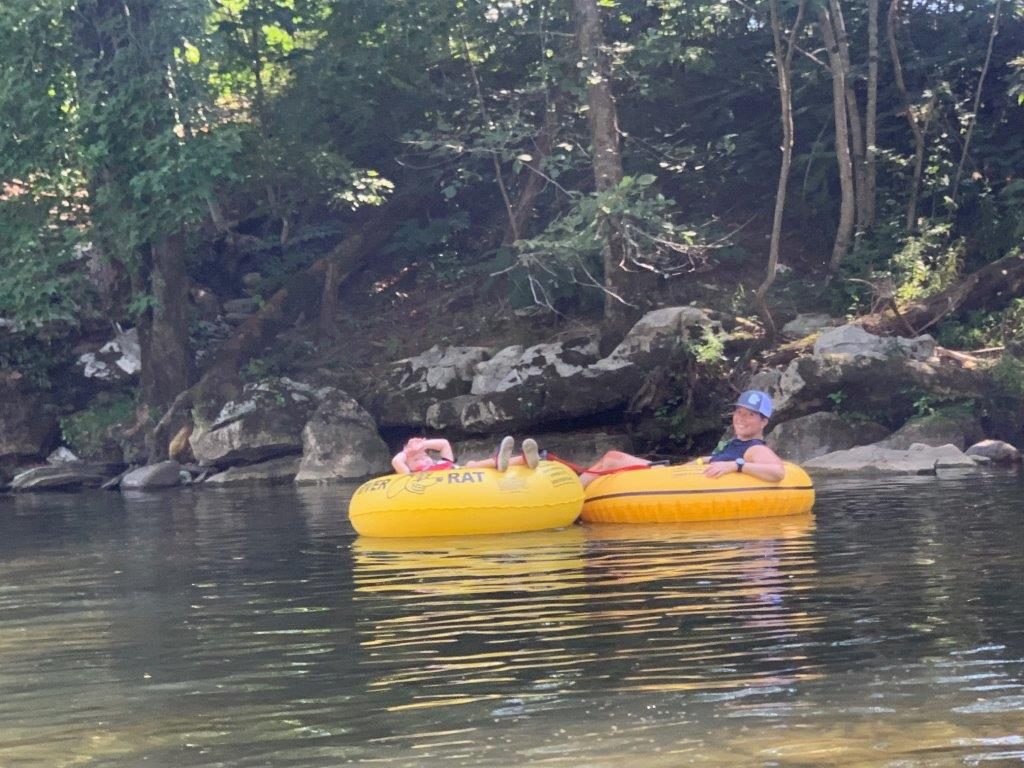 Floating with my youngest in a yellow inner tube down the river.