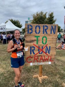 Standing next to a Born to Crawl sign at the finish festival.