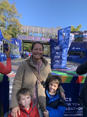 Standing in front of the finish line with my boys the day before the race.