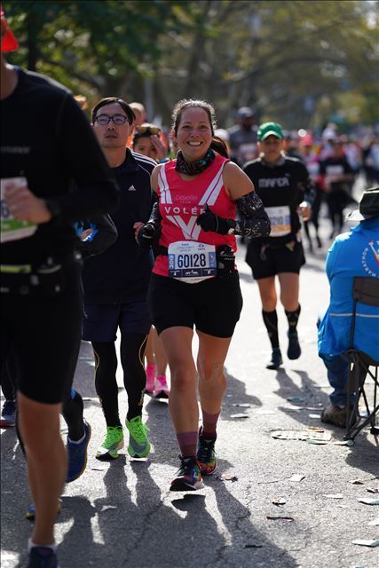 All smiles and wearing my red Oiselle Volee singlet during the New York marathon.