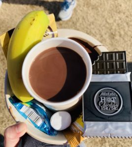 A bowl with chocolate dip, a banana, marshmallow, rice Krispy treat, and a few other goodies, and my cup of hot chocolate.
