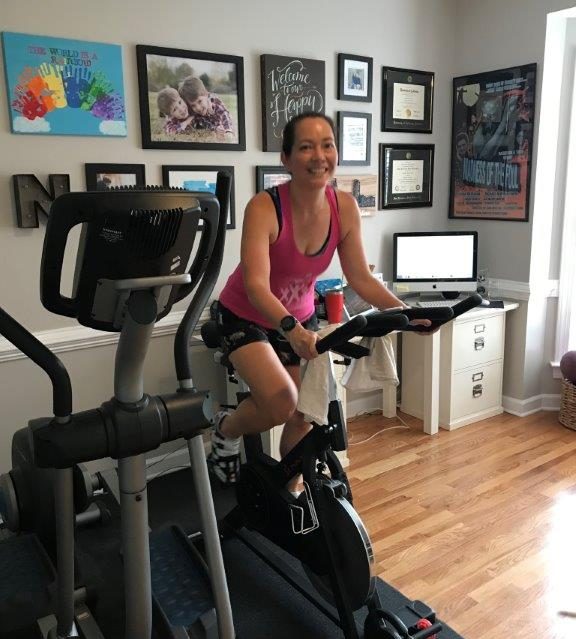 Sitting on my Sunny Fitness and Health spin bike, testing out my Peloton hack.