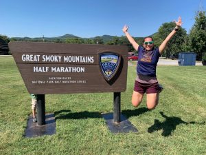 Jumping in front of the Great Smoky Mountain half marathon sign.